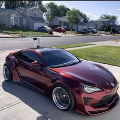 a red sports car parked in front of a house