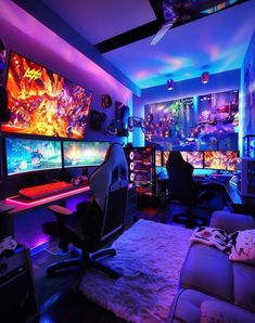 a living room filled with lots of computer monitors and gaming equipment on top of a white rug