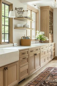 a large kitchen with wooden cabinets and white counter tops, along with a rug on the floor