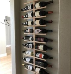 a wall mounted wine rack filled with bottles