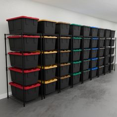 several bins are lined up against the wall