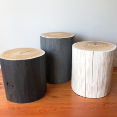 three wooden stools sitting on top of a hard wood floor