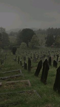 an old cemetery with many headstones in the grass