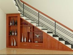 the stairs are made of wood and have glass shelves under them with vases on each shelf