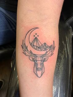 a tattoo on the leg of a person with a deer head