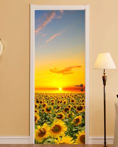 an open door with sunflowers in the background and a blue sky at sunset