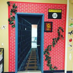 the hallway is decorated with red bricks and ivys on the wall, along with an open door that leads to another room