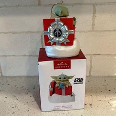 a star wars figurine sitting on top of a box with a keychain attached to it