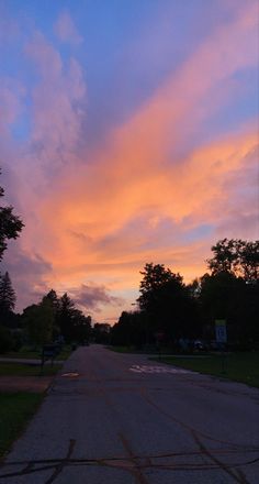 the sky is pink and blue as the sun sets