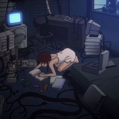 a person laying on the floor in front of computer equipment