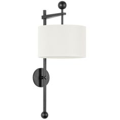 a wall mounted lamp with a white shade on the top and black metal frame around it