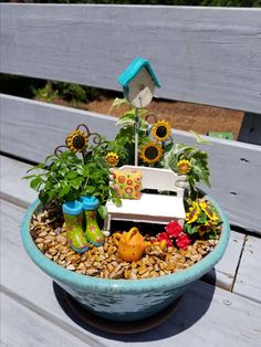 a potted planter filled with lots of flowers and gardening items sitting on top of a wooden bench