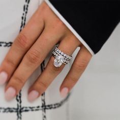 a close up of a person's hand with a ring on their finger