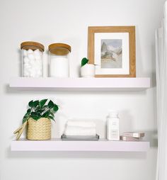 two white shelves in a bathroom filled with toiletries