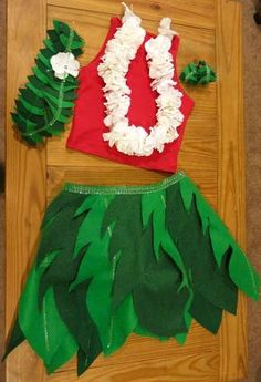 a green skirt with white flowers on it next to a red shirt and other items