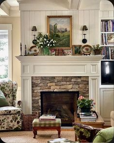 a living room filled with furniture and a fire place in front of a tv mounted above a fireplace