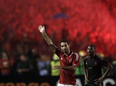 two soccer players are applauding on the field