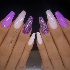 two hands with purple and white nail polishes on their nails, one is holding the other