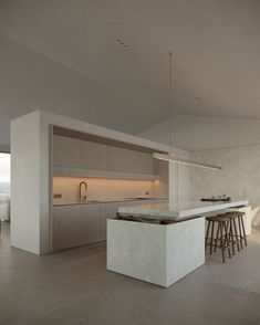 a kitchen with an island in the middle and bar stools at the back side