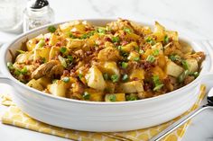 a white bowl filled with food on top of a table