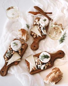 cheeses and crackers on wooden cutting boards with glasses of wine