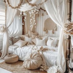 a bed with lots of pillows and curtains