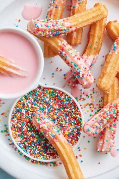 sprinkled donuts and dipping sauce on a plate