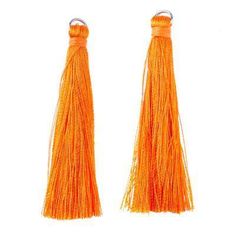 two orange tassels hanging from hooks