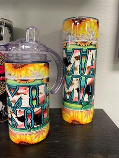 two colorful cups sitting next to each other on a table