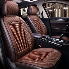 the interior of a car with brown leather and stitching on the front seat covers