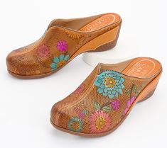 Step into a pair of these perforated leather clogs and let your personality bloom. The painted floral design adds a splash of color and artistry to every step. From L'Artiste by Spring Step. Multicolor Slip-on Clogs For Spring, Spring Slip-on Brown Clogs, Slip-on Brown Clogs For Spring, Multicolor Leather Clogs For Spring, Slip-on Clogs With Removable Insole For Spring, Spring Multicolor Leather Mules, Brown Slip-on Clogs For Spring, Slip-on Clogs With Leather Sole For Spring, Multicolor Leather Clogs With Rubber Sole