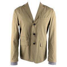 DSQUARED2 sport coat comes in a khaki cotton woven material with a full liner featuring a notch lapel, flap pockets, single back vent, and a three button closure. Made in Italy.New with Tags. Marked: 50 Measurements: Shoulder: 18 inches Chest: 40 inches Sleeve: 27 inches Length: 27.5 inches Reference: 125653 Category: Sport Coat More Details Brand: DSQUARED2 Size: 40 Chest Size: 40 Gender: Male Color: Khaki Pattern: Solid Fabric: Cotton Style: Notch Lapel Condition: 1. New wtih Tags Age Group: A Brown Cotton Sport Coat For Work, Brown Cotton Sport Coat With Notch Lapel, Brown Single-breasted Cotton Blazer, Khaki Blazer With Patch Pockets And Lapel Collar, Classic Khaki Cotton Sport Coat, Brown Cotton Blazer With Patch Pockets, Brown Single Breasted Cotton Sport Coat, Brown Single-breasted Cotton Sport Coat, Khaki Sport Coat With Welt Pockets And Lapel Collar