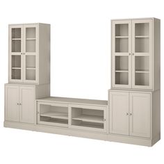 a white entertainment center with glass doors on the front and shelves below it, against a white background