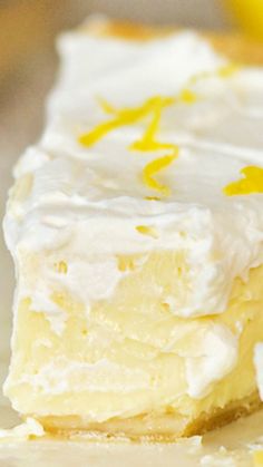 a close up of a piece of cake with frosting and lemons on it