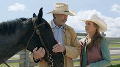 a man and woman standing next to a horse