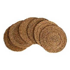 four round placemats made out of straw, on a white background with clipping for text