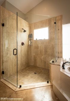 a bathroom with a walk in shower next to a sink