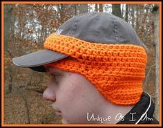 a man wearing an orange crochet hat with a gray cap on his head