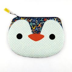 a close up of a small zipper bag with a penguin face on the front and bottom