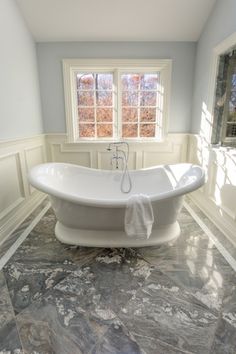 a bath tub sitting in the middle of a bathroom