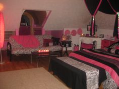 a bedroom with zebra print furniture and pink accents