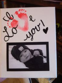 an instagramted photo of a baby's hand and foot print with the words i love you on it