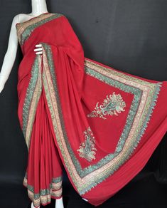 Pure Crepe Sozni and Tilla Zari  Hand Embroidered Saree             "With Hand Embroidered Blouse"   This pure crepe Kashmiri saree is a stunning showcase of traditional craftsmanship, featuring intricate Sozni and Tilla border embroidery. The delicate work is complemented by two beautifully designed corners, adding a touch of elegance to the overall look. Lightweight and comfortable, this saree drapes gracefully, making it ideal for both festive occasions and everyday wear. Paired with a matching blouse, this ensemble beautifully blends cultural heritage with modern style, ensuring you stand out in any gathering. The ethnic Saree is crafted in the finesse of Silk, which gives it a glamorous look. Base Color : Maroon Finish: Unstitched    Fabric : Pure Crepe Saree                Pure Crepe Designer Bollywood Pre-draped Embroidered Saree, Bollywood Style Designer Embroidered Pre-draped Saree, Transitional Chinon Saree With Resham Embroidery, Transitional Season Silk Saree With Intricate Embroidery, Traditional Red Embroidered Pre-draped Saree, Traditional Red Pre-draped Embroidered Saree, Fitted Chinon Traditional Wear With Embroidered Border, Festive Embroidered Pre-draped Saree For Transitional Season, Festive Embroidered Pre-draped Saree