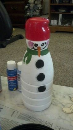 a snowman made out of cups sitting on top of a table