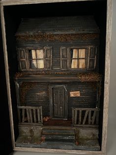 an old doll house in a wooden frame