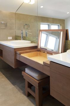 a bathroom with two sinks and a large mirror