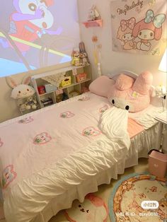 a bedroom with a bed, rugs and stuffed animals on the wall next to it