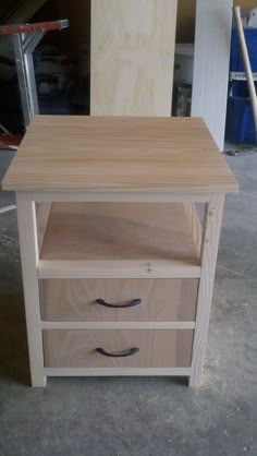 a wooden table with three drawers in the process of being built by someone who is working on it