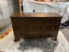 a wooden dresser sitting on top of a floor