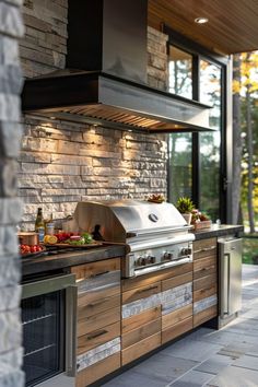 an outdoor kitchen with stainless steel and wood